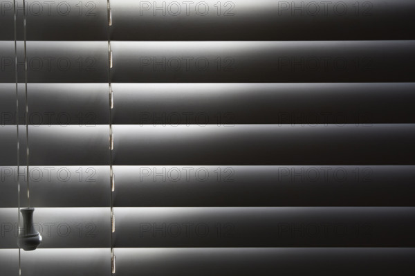 Close-up of window blinds with sunlight. New York City, New York State, USA.