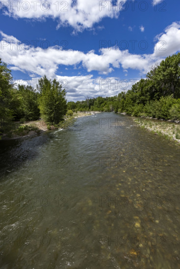 White puffy clouds above Big Wood River . Bellevue, Idaho, USA.