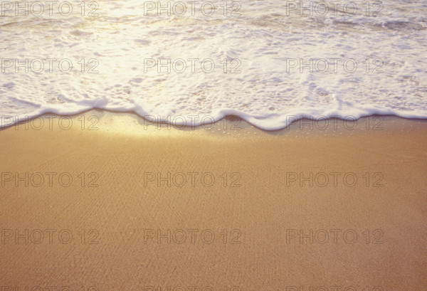 Close-up of sea wave washing sandy beach. Spring Lake, New Jersey, USA.
