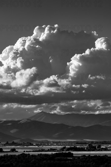 White puffy clouds over mountains, black and white. Bellevue, Idaho, USA.