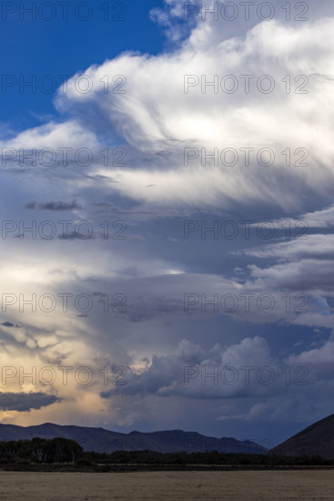 Dramatic clouds over mountains and field. Bellevue, Idaho, USA.