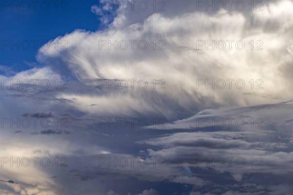 Dramatic white clouds in sunlight on blue sky. Bellevue, Idaho, USA.