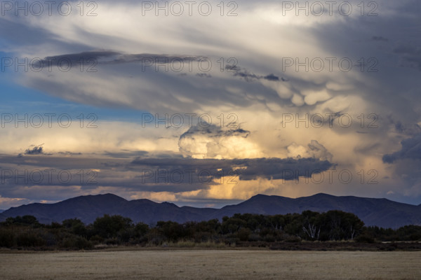 Dramatic clouds over mountains and field. Bellevue, Idaho, USA.