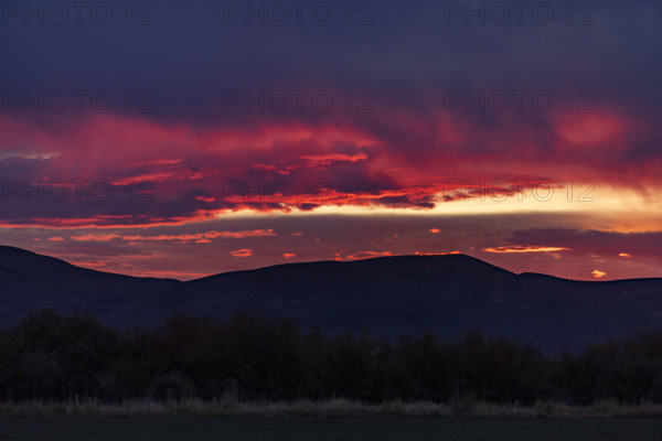 Dramatic clouds over mountains and field. Bellevue, Idaho, USA.