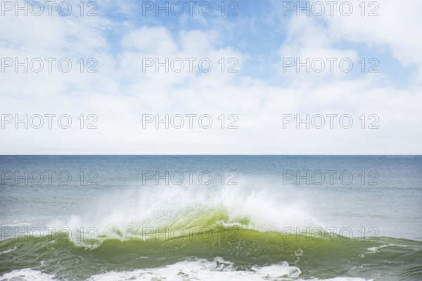 Ocean wave splashing on shore. Nantucket, Massachusetts, USA.