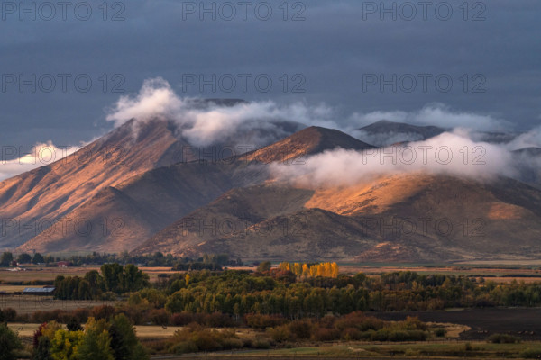 Clouds covering hills in late afternoon light. Bellevue, Idaho, USA.