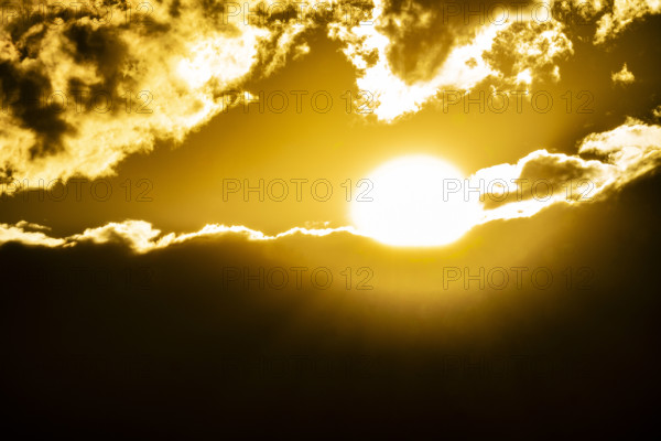 Golden sun setting behind clouds. Bellevue, Idaho, USA.
