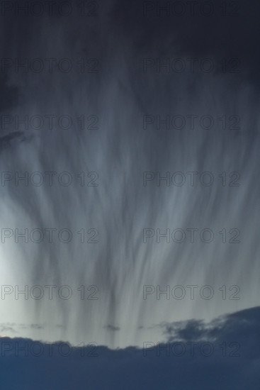 Heavy rain pouring from gray clouds. Bellevue, Idaho, USA.