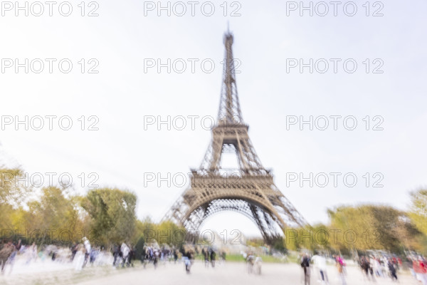 Tourists near Eiffel Tower, blurred motion. Paris, Ile de France, France.