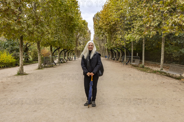 Portrait of smiling woman in Jardin des Plantes. Paris, Ile de France, France.