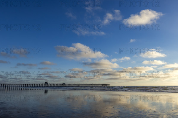Oceanside Pier and calm ocean in late afternoon. Oceanside, California, USA.