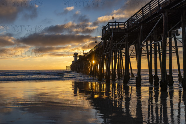 Oceanside Pier and calm ocean at sunset. Oceanside, California, USA.