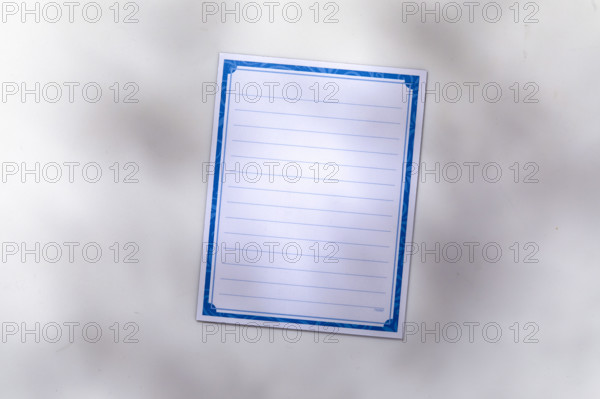 Blank lined notepad on white background. New York City, New York State, USA.