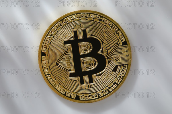Bitcoin on dappled light background. New York City, New York State, USA.