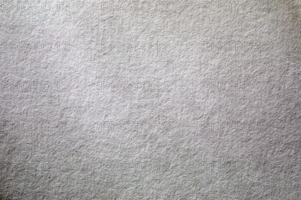 Dappled light on textured white paper. New York City, New York State, USA.