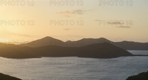 Calm ocean and mountains at sunrise. New York City, New York State, USA.