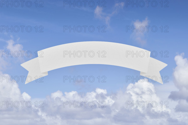 Blank banner in front of blue sky and white clouds. New York City, New York State, USA.