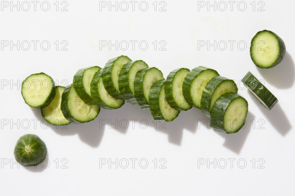 Sliced cucumber on white background. New York City, New York State, USA.