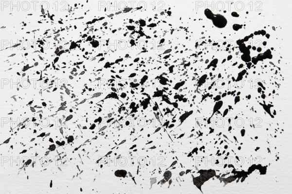 Black paint spatter on white background. New York City, New York State, USA.