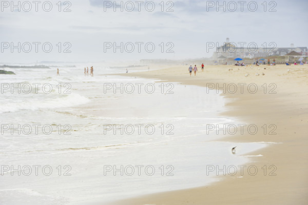 Waves washing beach on cloudy day. Spring Lake, New Jersey, USA.