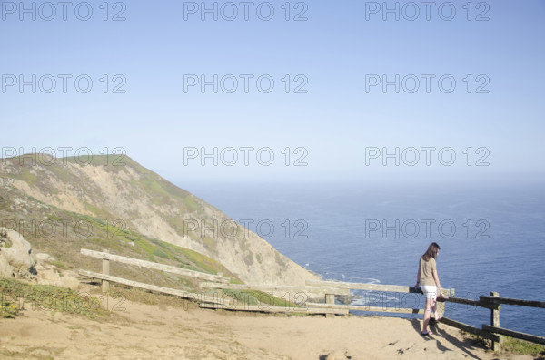 Woman looking at view at Point Reyes National Seashore, Inverness, California, USA.