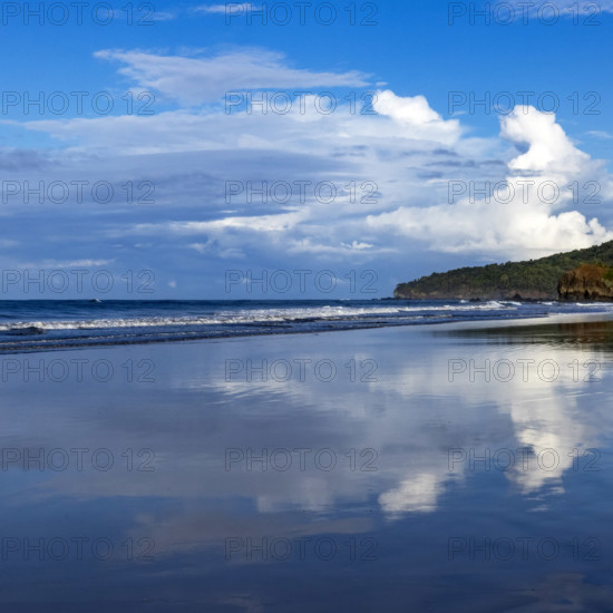 Sky and clouds reflecting in calm sea surface at dawn, Playa Grande, Guanacaste, Costa Rica.