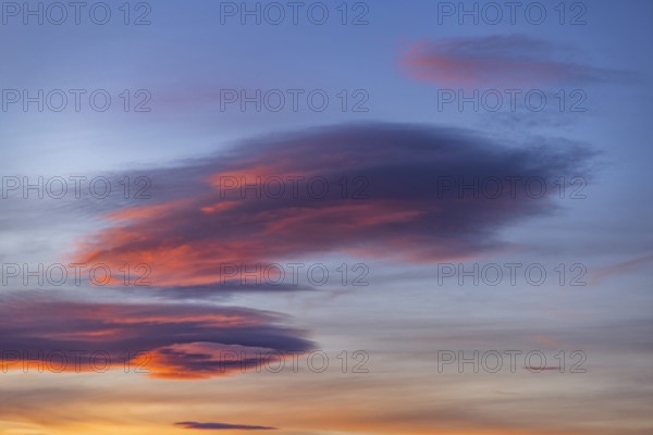 Pink lenticular clouds on sky at sunset, Gordes, Vaucluse, France.