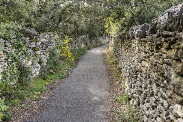 Empty path between old stone walls, Gordes, Vaucluse, France.