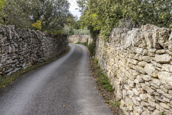 Empty path between old stone walls, Gordes, Vaucluse, France.