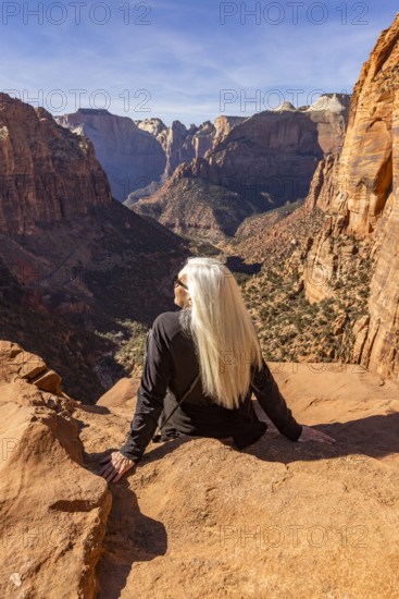 Rear view of senior blonde woman at Zion Overlook, Zion National Park, Utah, USA.
