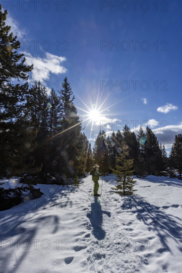 Senior woman snowshoeing in Sun Valley, Sun Valley, Idaho, USA.