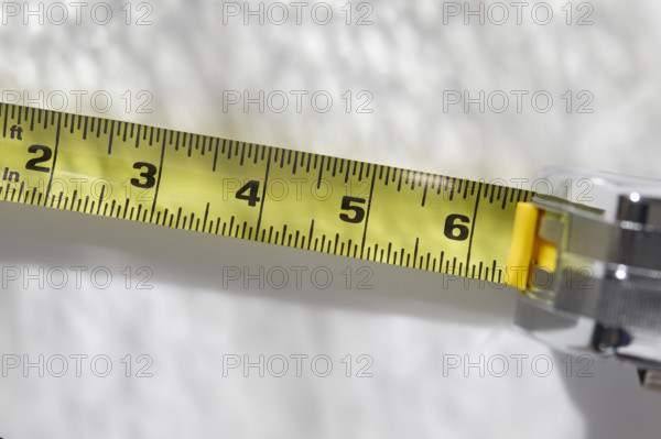 Close-up of tape measure on white background, New York City, New York, USA.