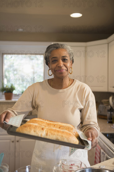 Portrait of smiling woman baking in kitchen, Richmond, Virginia, USA.
