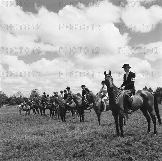 Kuwinda horse show. Seated riders in uniform line up to compete in the class 4 novice category of the Kuwinda horse show. Kuwinda, Nairobi, Kenya, 5 December 1954. Nairobi, Nairobi Area, Kenya, Eastern Africa, Africa.