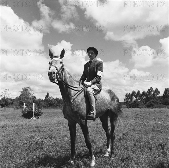 Novice rider. Female rider number seven on horseback competing in the class 4 novice category of the Kuwinda horse show. Kuwinda, Nairobi, Kenya, 5 December 1954. Nairobi, Nairobi Area, Kenya, Eastern Africa, Africa.