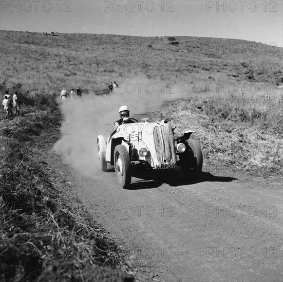 Zelda turns the bend. Racing driver Zelda Hughes representing Ford in the Menengai hill climb. Menengai hill, Nakuru, Kenya, 12 December 1954. Nakuru, Rift Valley, Kenya, Eastern Africa, Africa.