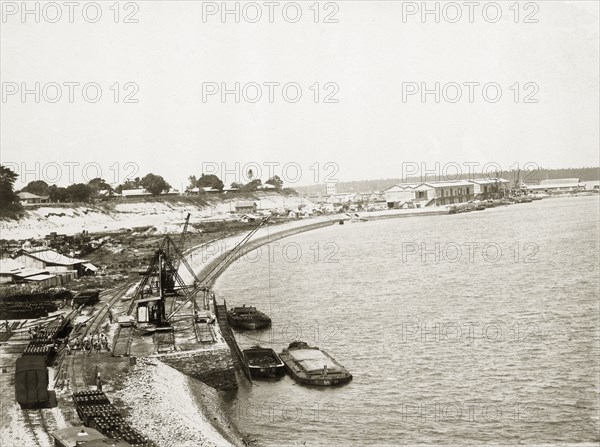 Railway depot at Kilindini harbour. A railway depot at Kilindini harbour showing transport barges and cranes. Mombasa, Kenya, circa 1930. Mombasa, Coast, Kenya, Eastern Africa, Africa.