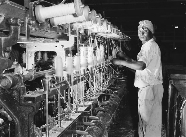 Spinning bobbins. A factory worker spins sisal fibre onto bobbins at Sisal Products Ltd. Grown commercially for its hard fibres, sisal is a cactus closely related to hemp that is used to make products such as twine, rope and sacks etc. Kenya, 18 February 1953. Kenya, Eastern Africa, Africa.