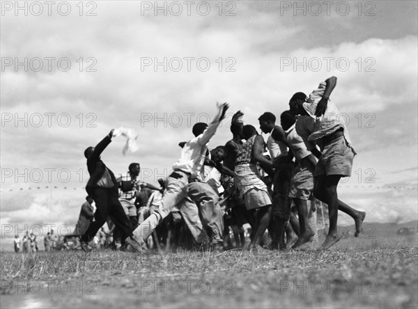 Wakamba dancing. A group of men from the east Kenyan Wakamba tribe dance at a 'ngoma', a word meaning drum that is also used to describe traditional celebrations. Kajiado, Kenya, 2 June 1953. Kajiado, Rift Valley, Kenya, Eastern Africa, Africa.