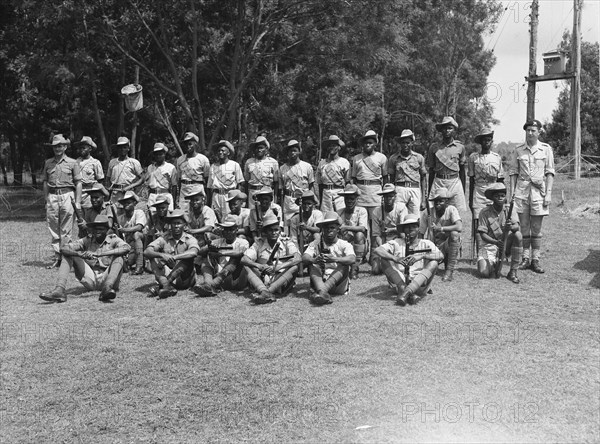 King's African Rifles. A line-up of armed and uniformed men in the King's African Rifles (KAR), the British colonial army in East Africa. The KAR performed both military and security functions and its choice of uniform reflected this, comprising a grey-blue shirt teamed with khaki. Kenya, June 1953. Kenya, Eastern Africa, Africa.