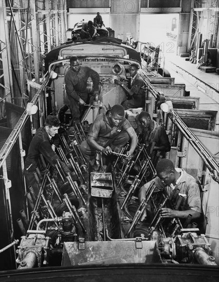 Railway engineering students, Nairobi. A publicity photograph from the East African Railways and Harbours Association (EAR&H) showing African students and a European instructor at work in the mechanical engineering workshops at Nairobi. Nairobi, Kenya, circa 1960. Nairobi, Nairobi Area, Kenya, Eastern Africa, Africa.