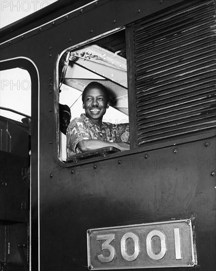 Julius Nyerere in the driver's seat. A publicity photograph from the East African Railways and Harbours Administration (EAR&H) shows Dr Julius Nyerere, the first leader of independent Tanganyika, sitting in the driver's seat of train, engine number 3001. Tanganyika (Tanzania), circa 1961. Tanzania, Eastern Africa, Africa.