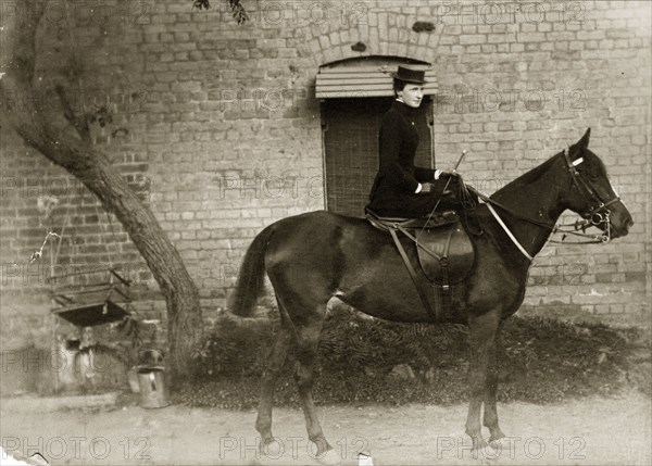 Victorian lady on horseback. Portrait of a Victorian lady on horseback. Dressed in black, she rides sidesaddle, a horsewhip held in her gloved hand. India, circa 1880. India, Southern Asia, Asia.