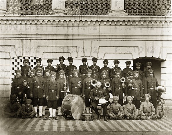 Indian military band. Portrait of an Indian military band in uniform. Amongst the traditionally Western musical instruments on display are clarinets, trumpets, a trombone, an unusual helicon tuba and a large bass drum. India, circa 1885. India, Southern Asia, Asia.