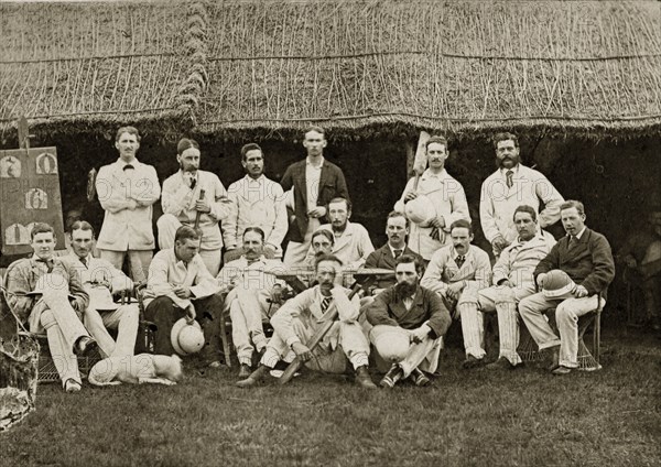 Satara and Poona cricket teams. Group portrait of the Satara and Poona cricket teams dressed in their sporting whites outside a clubhouse. Bombay (Mumbai), India, circa 1875. Mumbai, Maharashtra, India, Southern Asia, Asia.