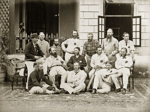 Members of the south Bombay cricket team. Group portrait of members of the south Bombay cricket team dressed in their whites outside a colonial-style buidling. Bombay (Mumbai), India, circa 1875. Mumbai, Maharashtra, India, Southern Asia, Asia.