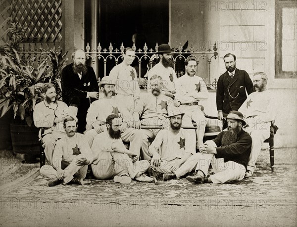 Members of the north Bombay cricket team. Members of the north Bombay cricket team pose for a group portrait outside a colonial-style buidling, possibly a clubhouse. The players wear distintive stars on their shirts. Bombay (Mumbai), India, circa 1875. Mumbai, Maharashtra, India, Southern Asia, Asia.