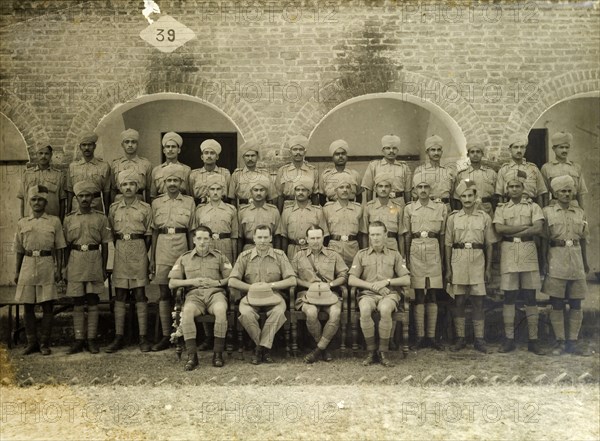Police wireless telegraphy course. Uniformed Indian and British officers in the Uttar Pradesh police force stand in line for a group portrait. They are attending the first wireless telegraphy course to be held in India at the Army Eastern Command Signal School. Bareilly, United Provinces (Uttar Pradesh), circa 1941. Bareilly, Uttar Pradesh, India, Southern Asia, Asia.