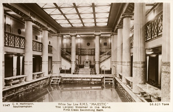 Swimming pool aboard the RMS Majestic. The grandiose interior of the first class swimming pool aboard the steam liner RMS Majestic. The pool was accessed by a staircase and surrounded by benches, balconies and pillars featuring mosaic patterns. Location unknown, circa 1925. Southampton, Hampshire, England (United Kingdom), Western Europe, Europe .