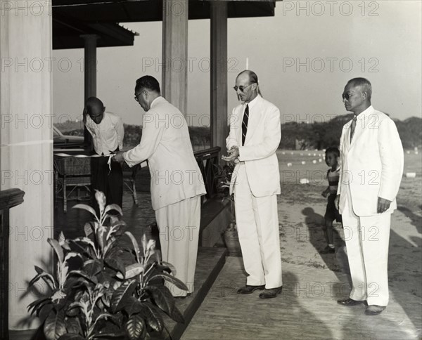 Opening the new club house. The Burmese President of the Rangoon Golf Club cuts a ribbon to declare the club's new club house open. Rangoon (Yangon), Burma (Myanmar), 23 February 1952. Yangon, Yangon, Burma (Myanmar), South East Asia, Asia.